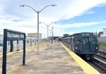 The Arnines enter Rockaway Park Station with many fans looking out the railfan window.